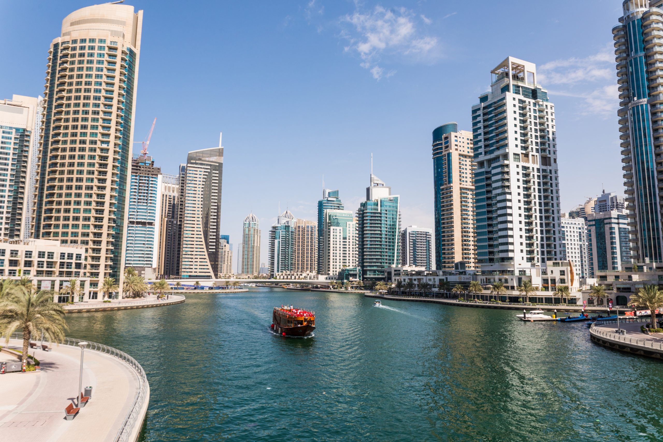 Panoramic skyline of Dubai featuring both Downtown and Marina, representing a real estate investment comparison.