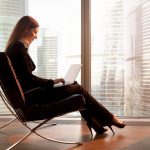 Young woman working on laptop on a luxury