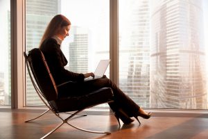 Young woman working on laptop on a luxury